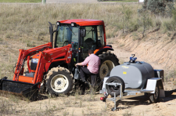 Red Tractor With Front Loader in a Field — Casali's in Mareeba, QLD
