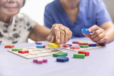 Personal Support Worker playing a game with an elderly woman