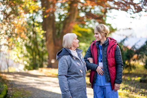 Personal Support Worker on a walk with an elderly woman