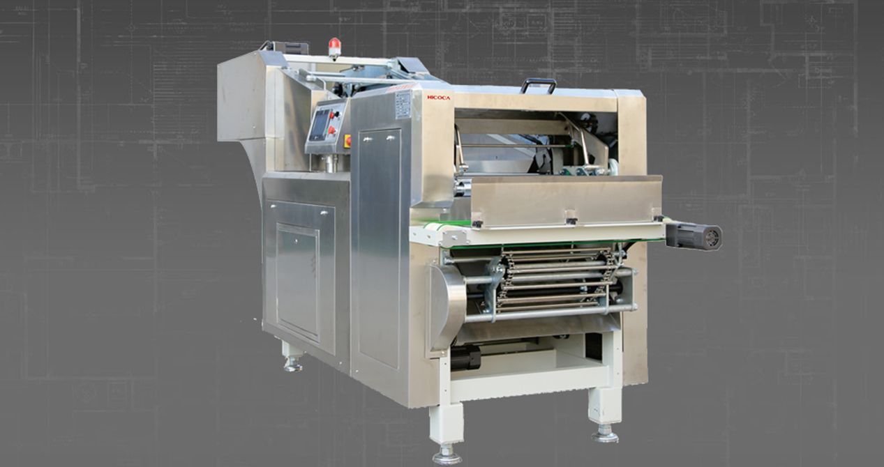 A stainless steel machine is sitting on a gray surface.