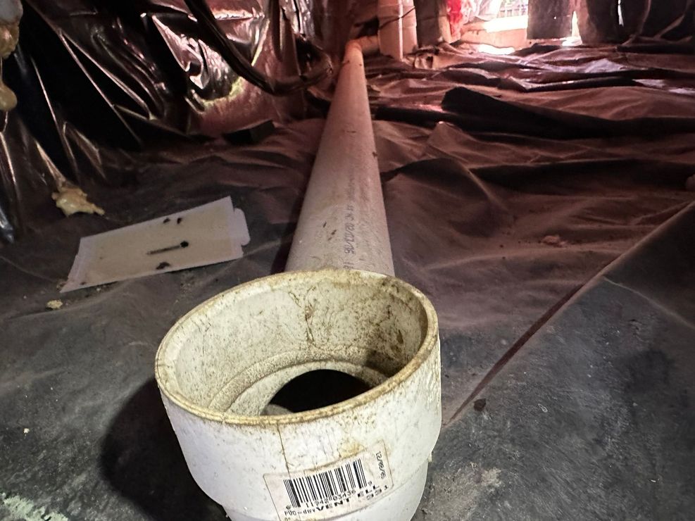 A white pipe with a hole in the middle of it