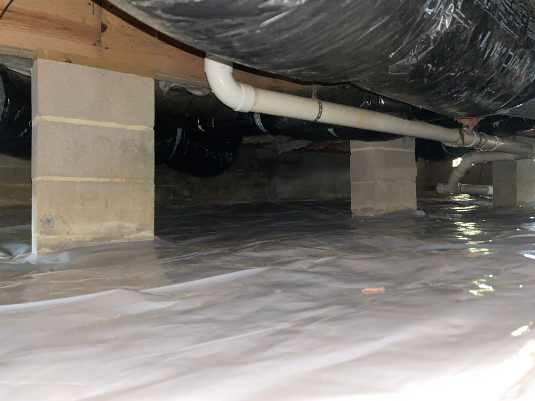 A basement with a lot of pipes coming out of it.