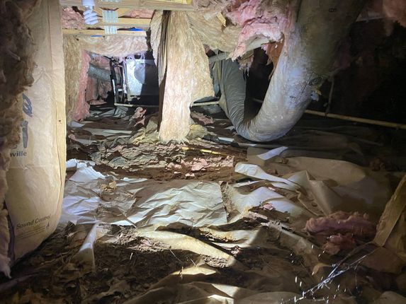 A picture of a flooded attic with a flashlight.