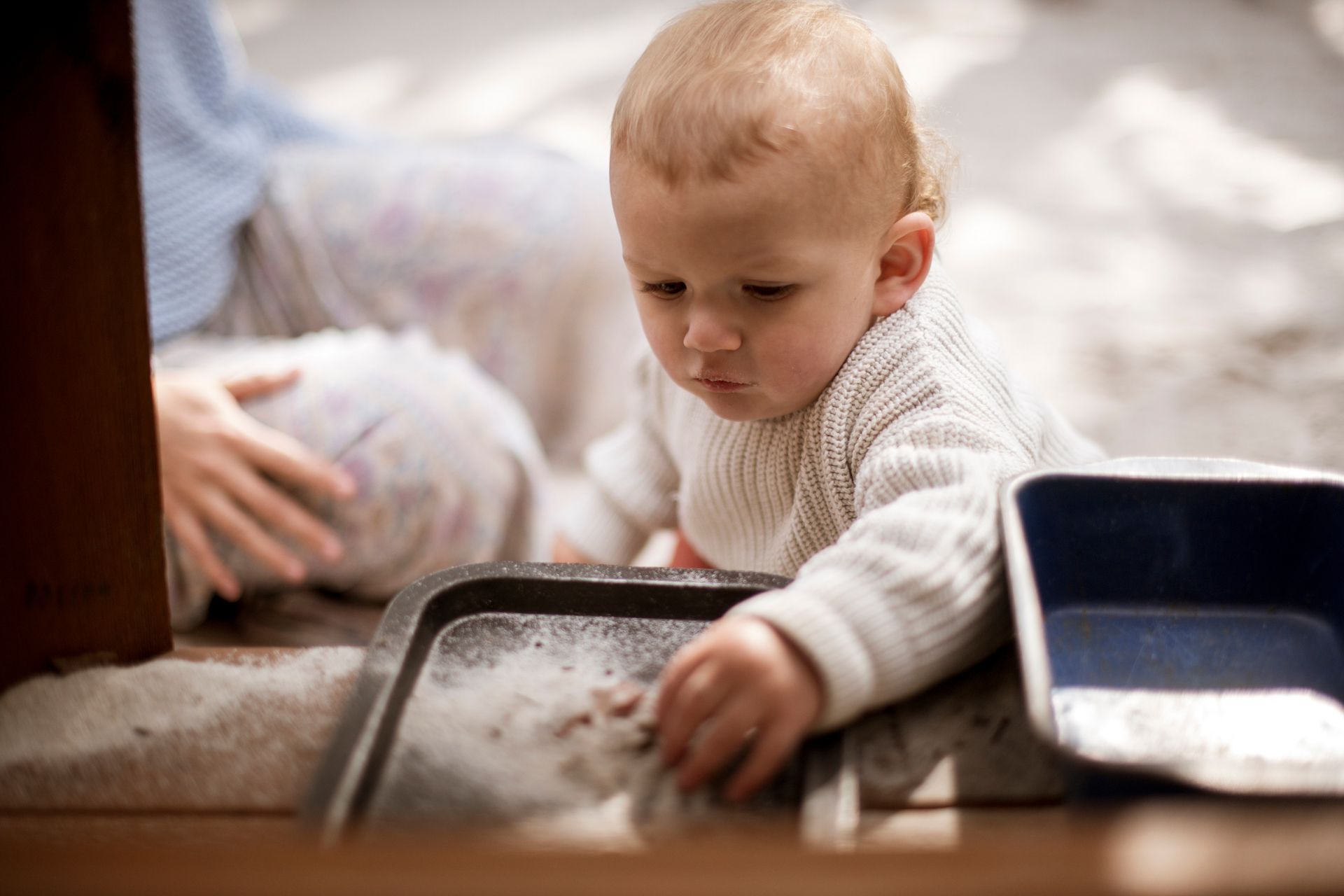Young child playing with pots and pans