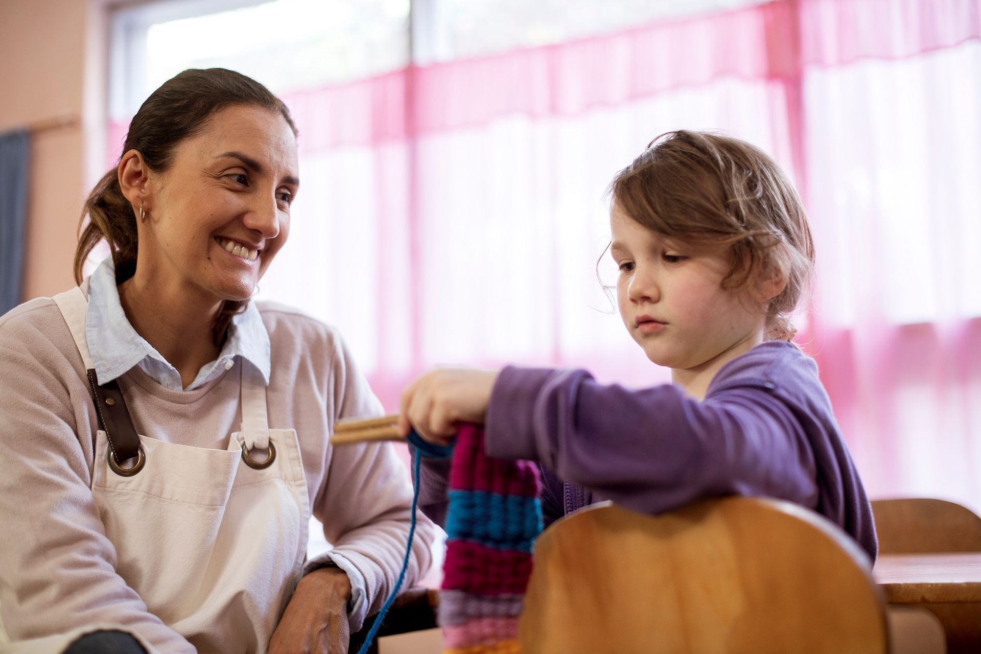 Class teacher and primary student sharing a quiet moment in a Steiner classroom