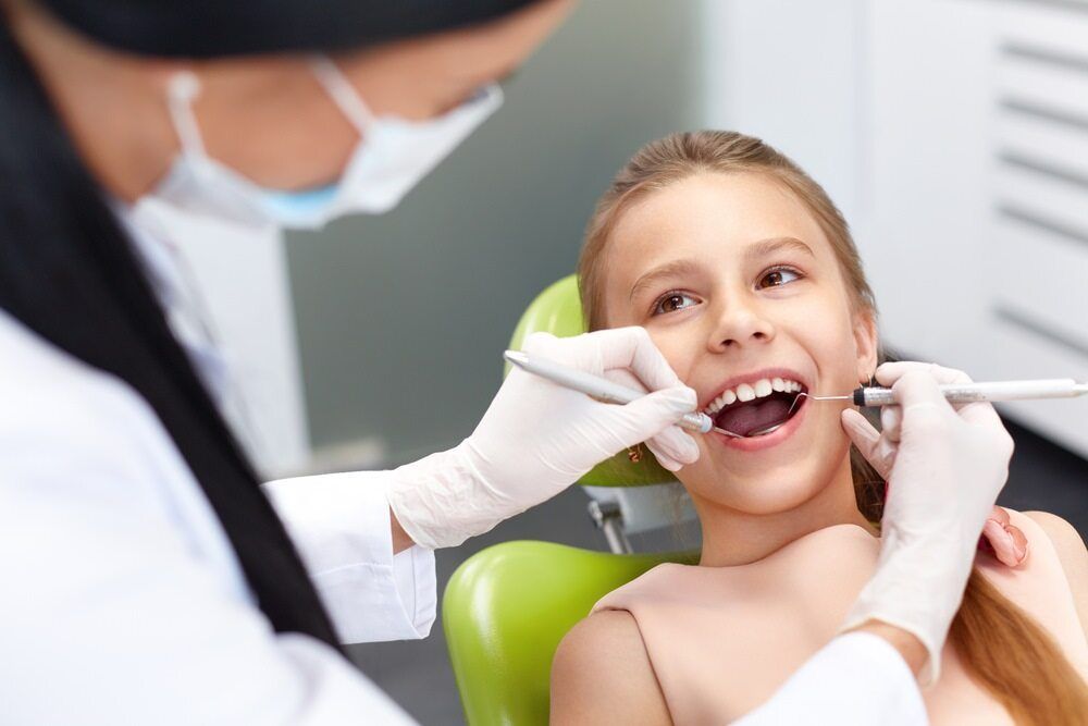 A Young Girl Is Sitting In A Dental Chair Getting Her Teeth — St Ives Dental Boutique In Saint Ives, NSW