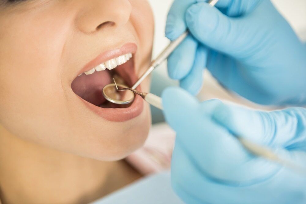 A Woman Is Getting Her Teeth Examined By A Dentist — St Ives Dental Boutique In Saint Ives, NSW