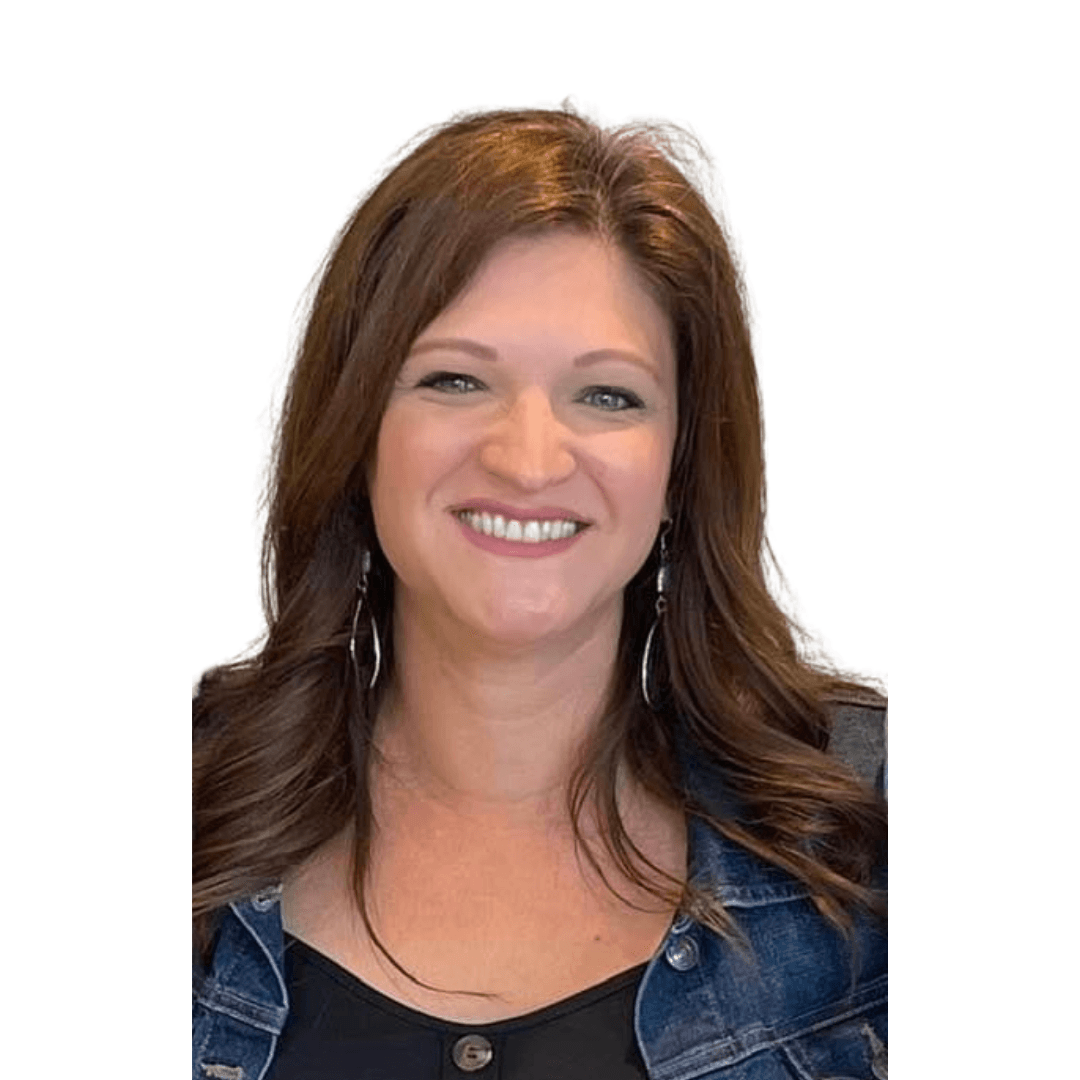 A woman wearing a denim jacket and a black shirt is smiling.