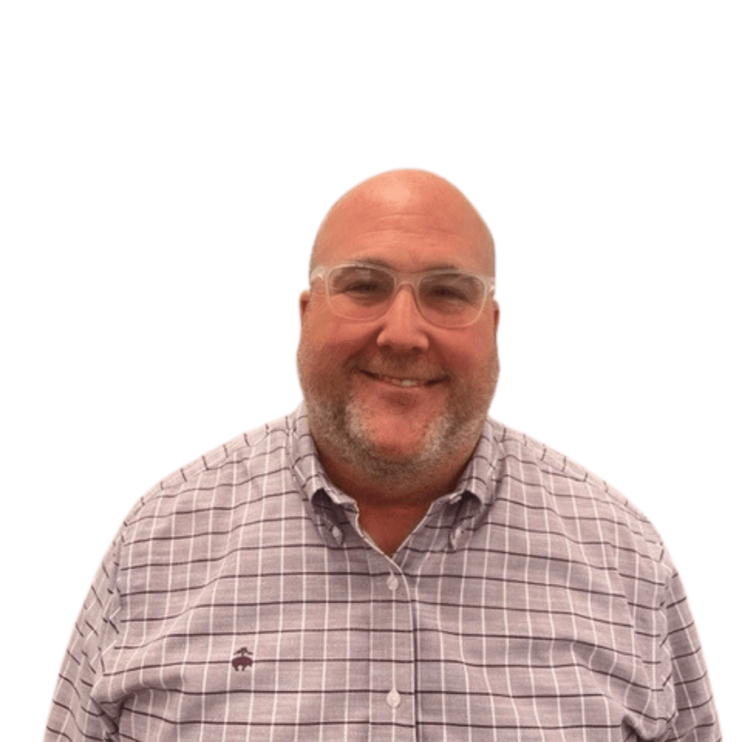 A man wearing glasses and a plaid shirt smiles for the camera