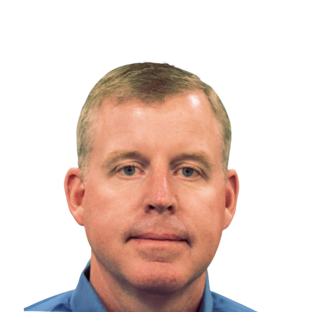 A man in a blue shirt is looking at the camera