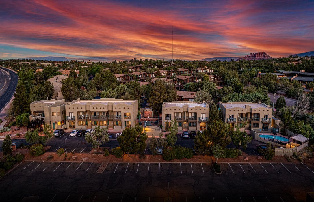 Aerial view of a building with parking lot at sunset near Sedona and Southwest Inn Sedona