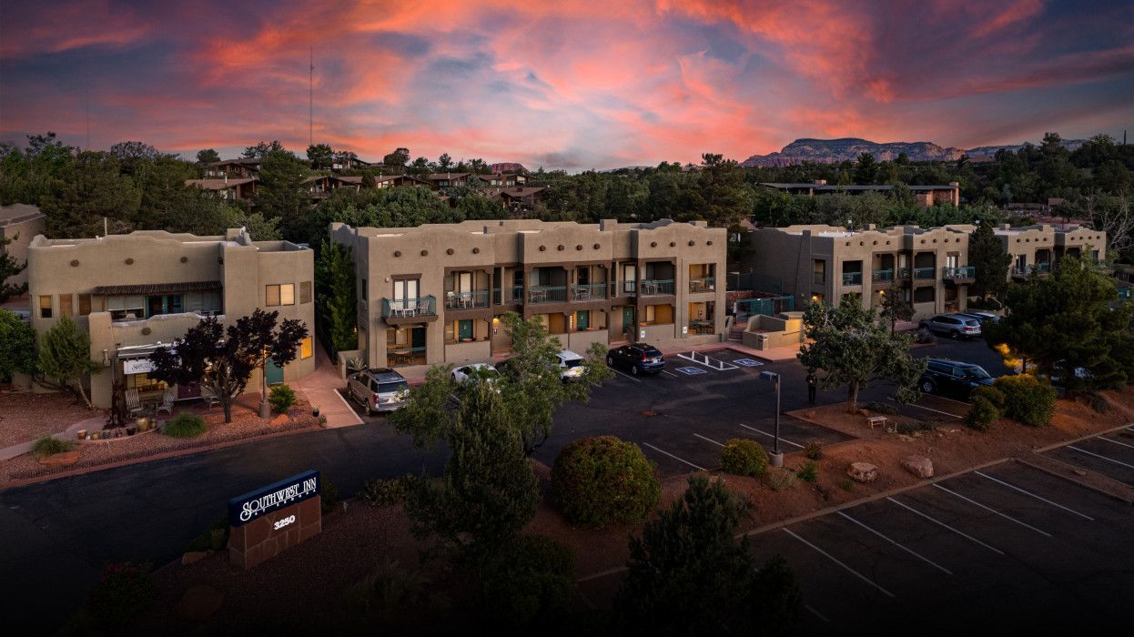 Aerial view of a row of apartment buildings with parking lot at sunset near Sedona and Southwest Inn Sedona