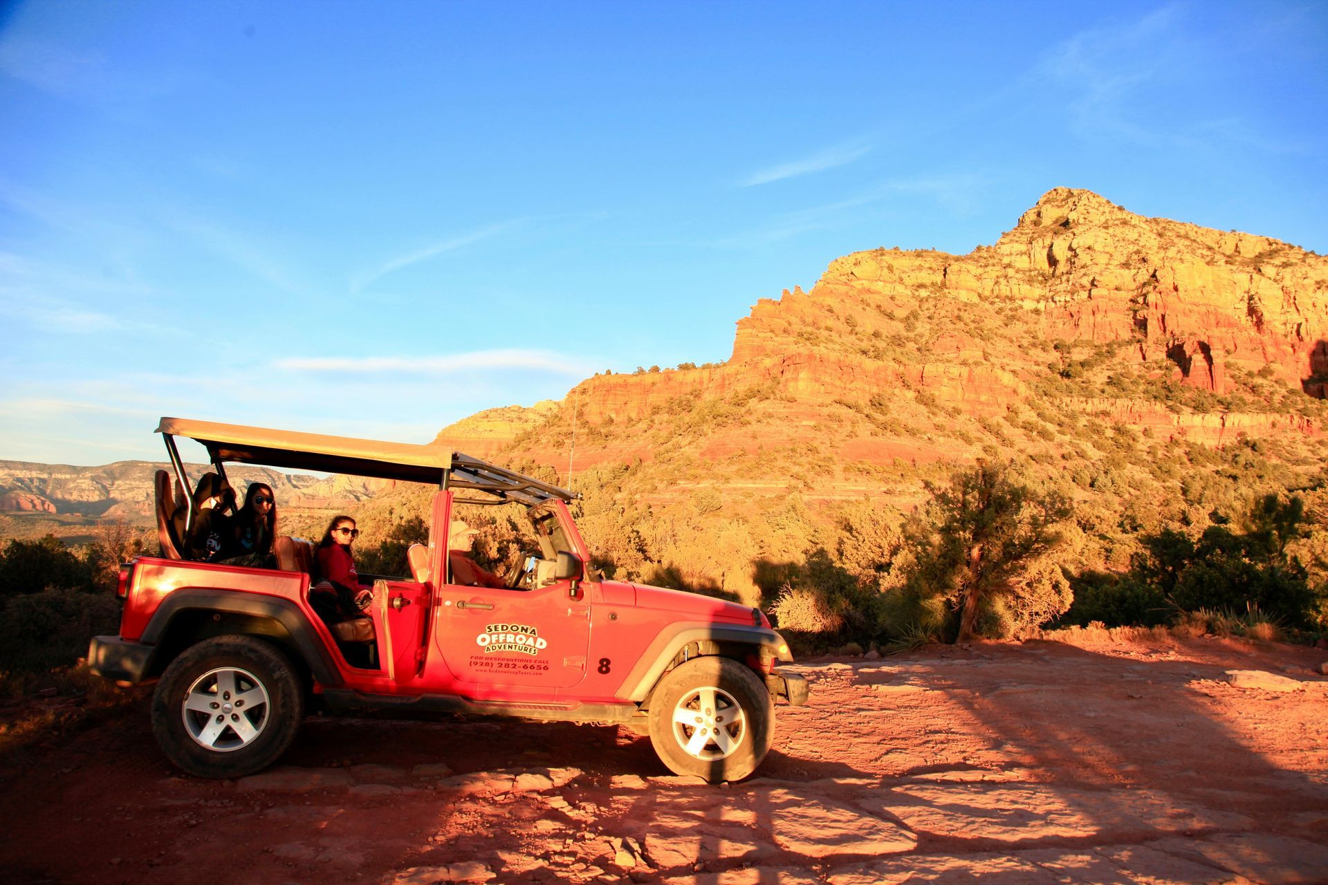 Red Jeep parked on a dirt road with Sedona mountain views near Southwest Inn Sedona