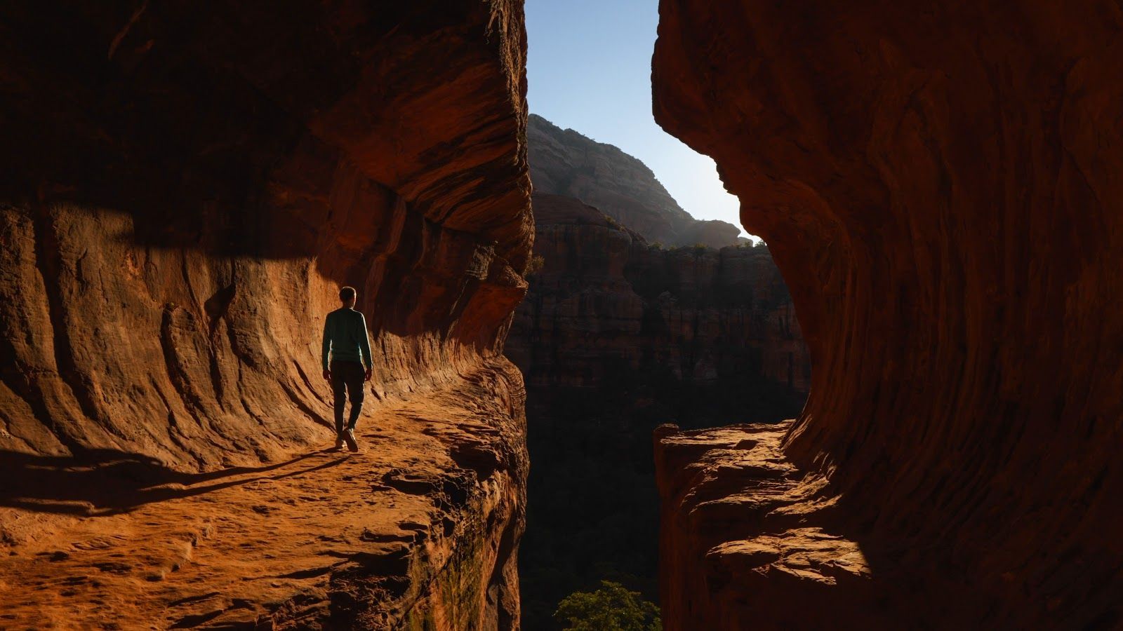 Hiker walking through a red rock canyon near Sedona