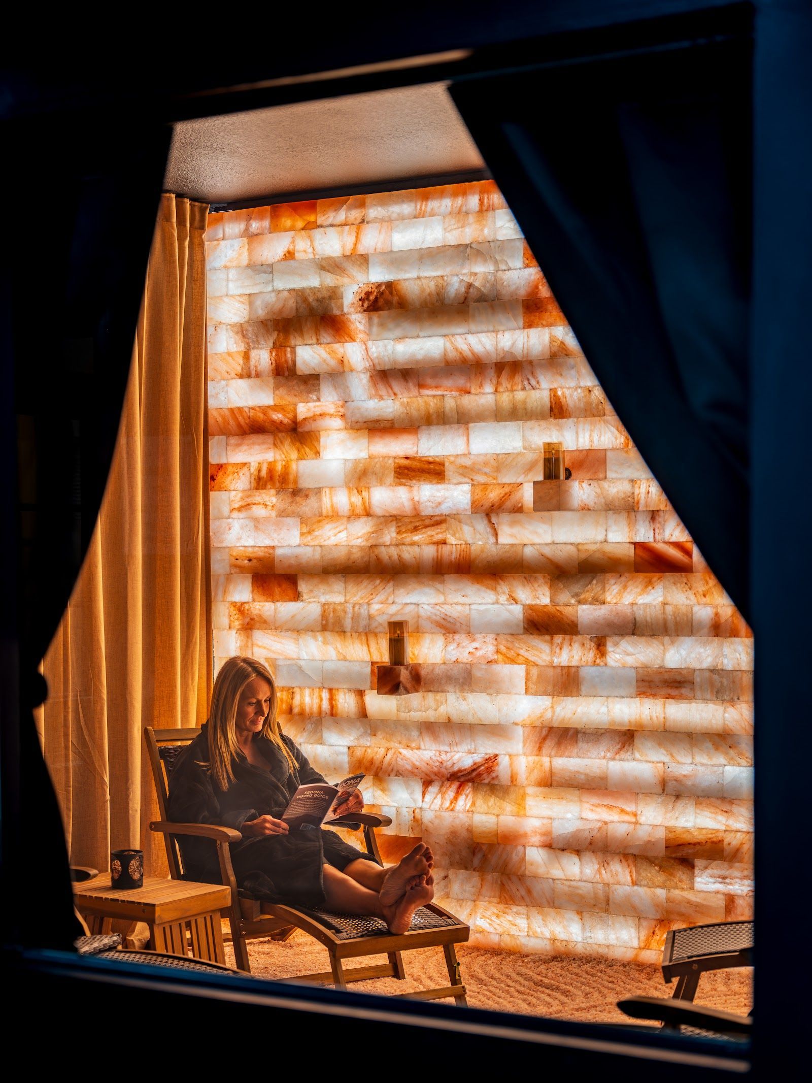 Guest relaxing with a book in the salt room at Southwest Inn at Sedona