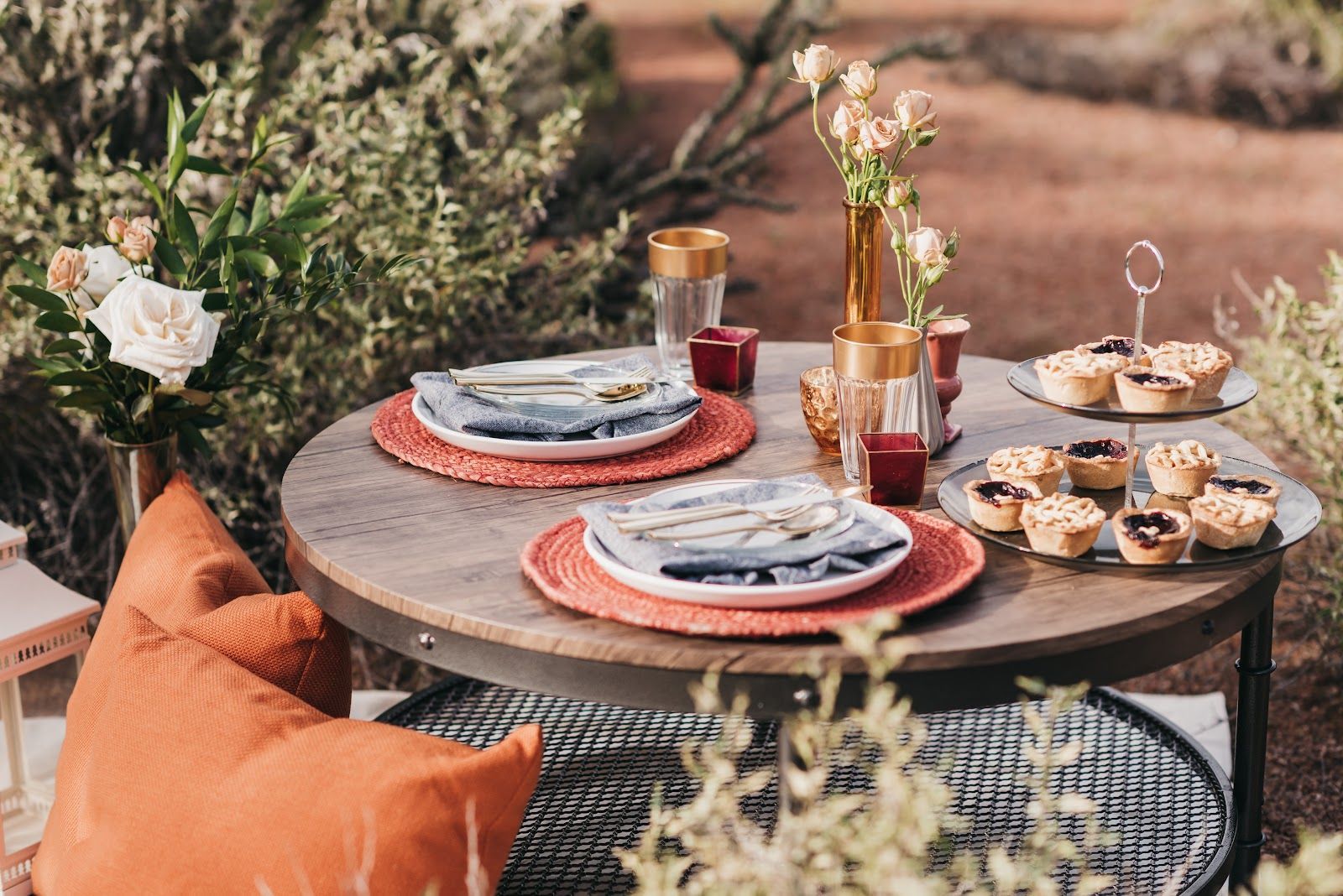 Outdoor Thanksgiving table set with plates and flowers at golden hour in Sedona