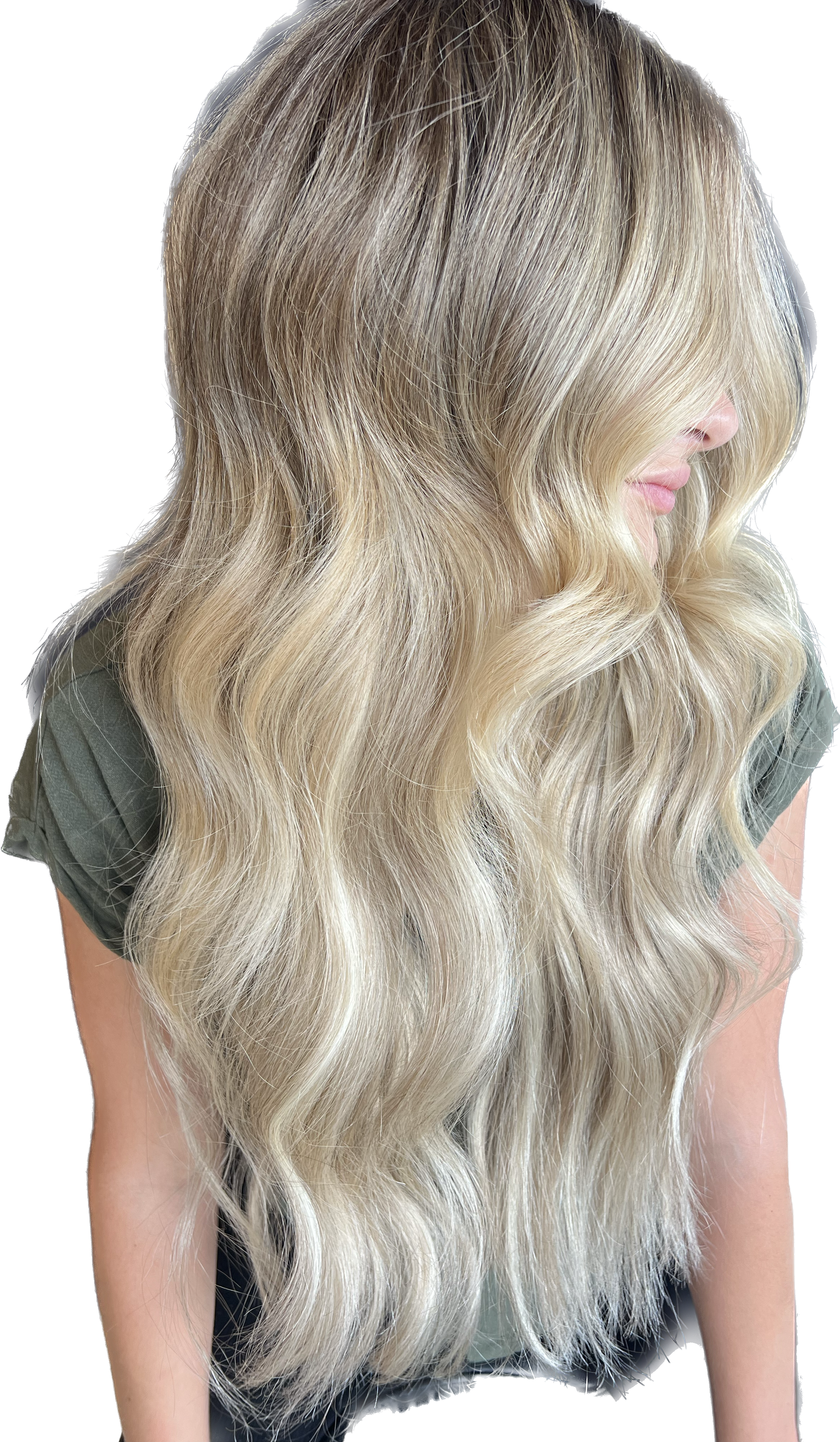 Long, wavy blonde hair; woman's back to camera; wearing a green shirt.
