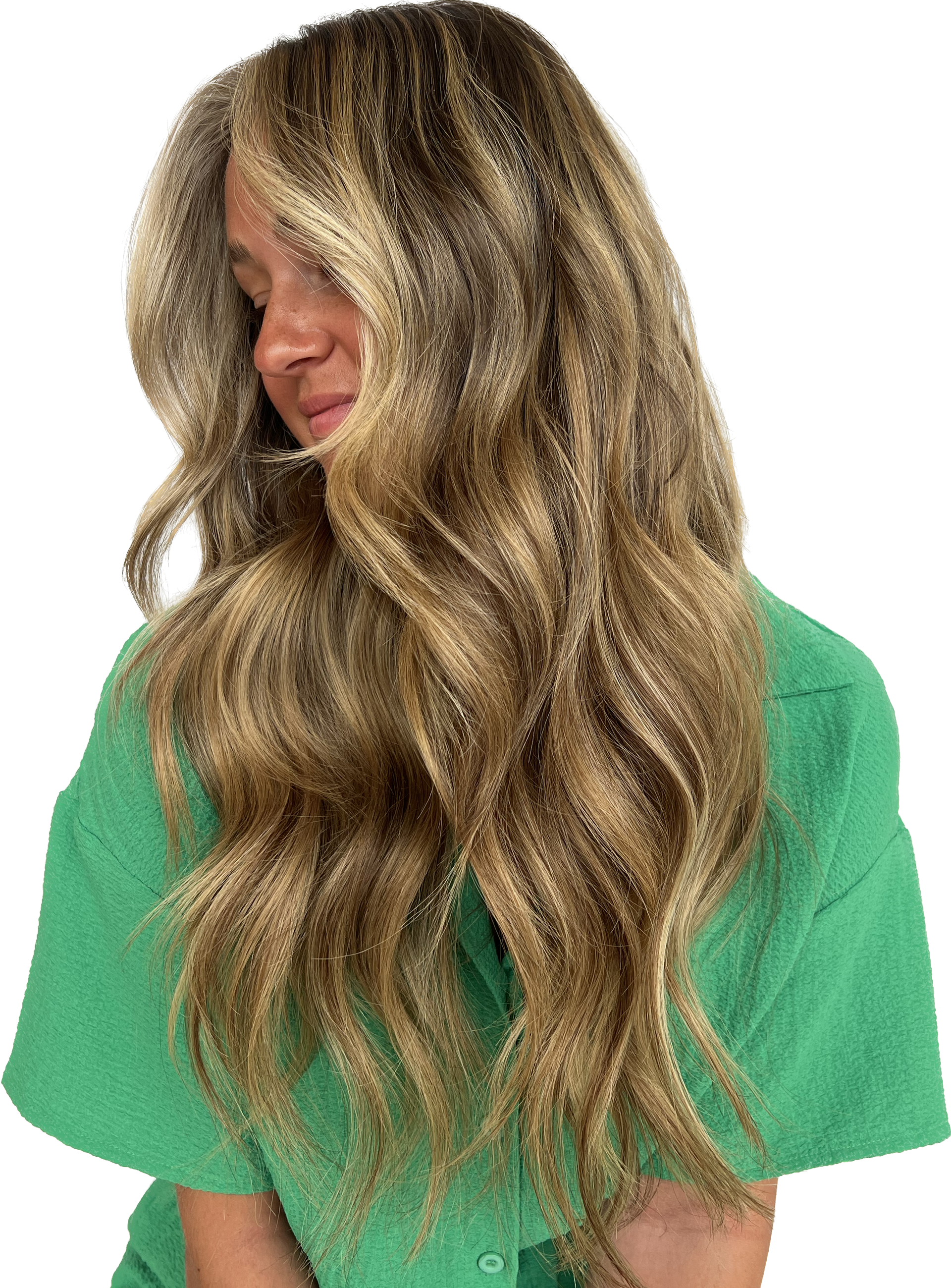 Woman with long, wavy blonde and brown hair, wearing a green shirt, looking down.