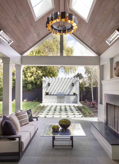 A living room with a vaulted ceiling and a fireplace