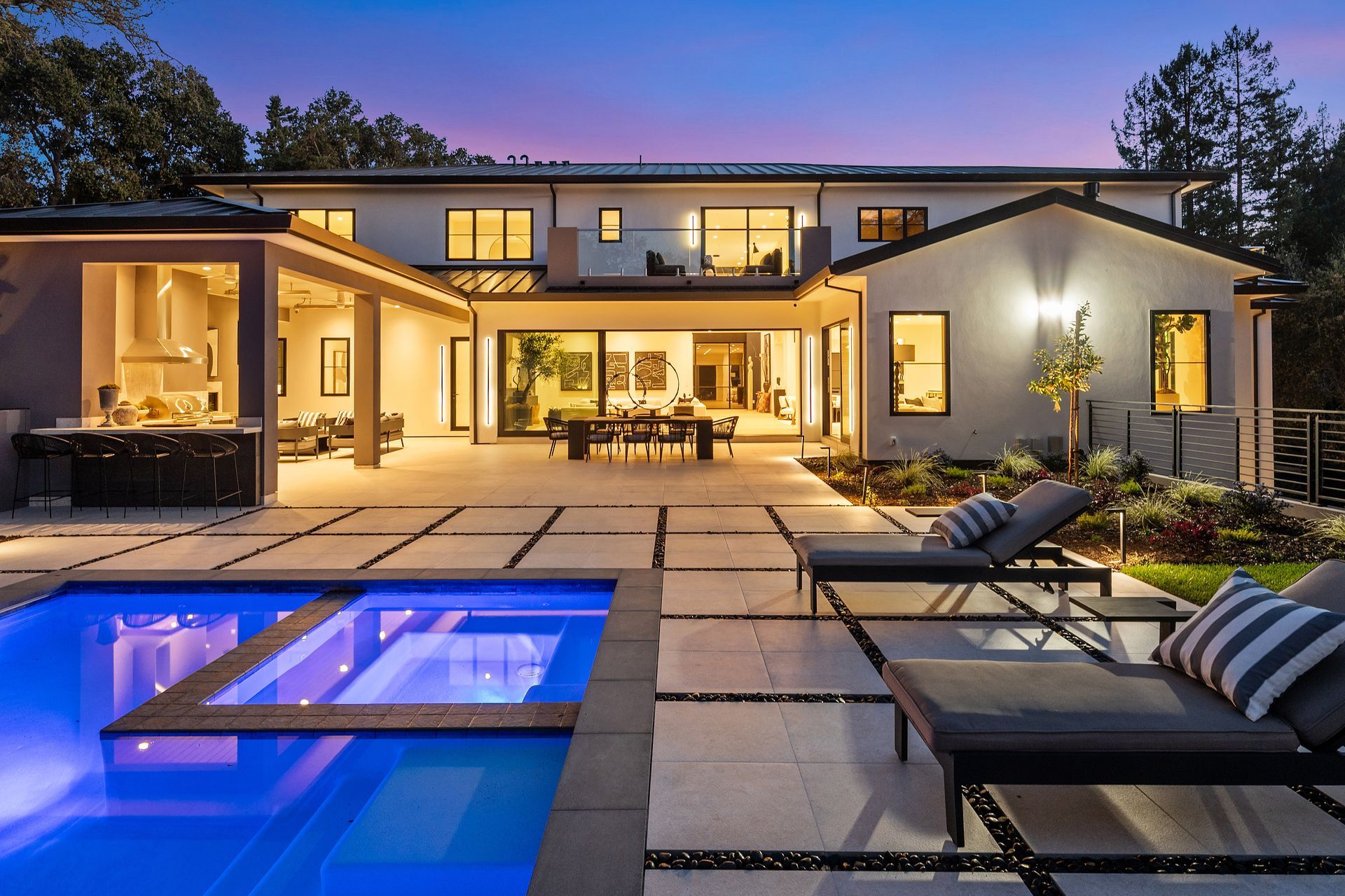 A large house with a swimming pool in front of it