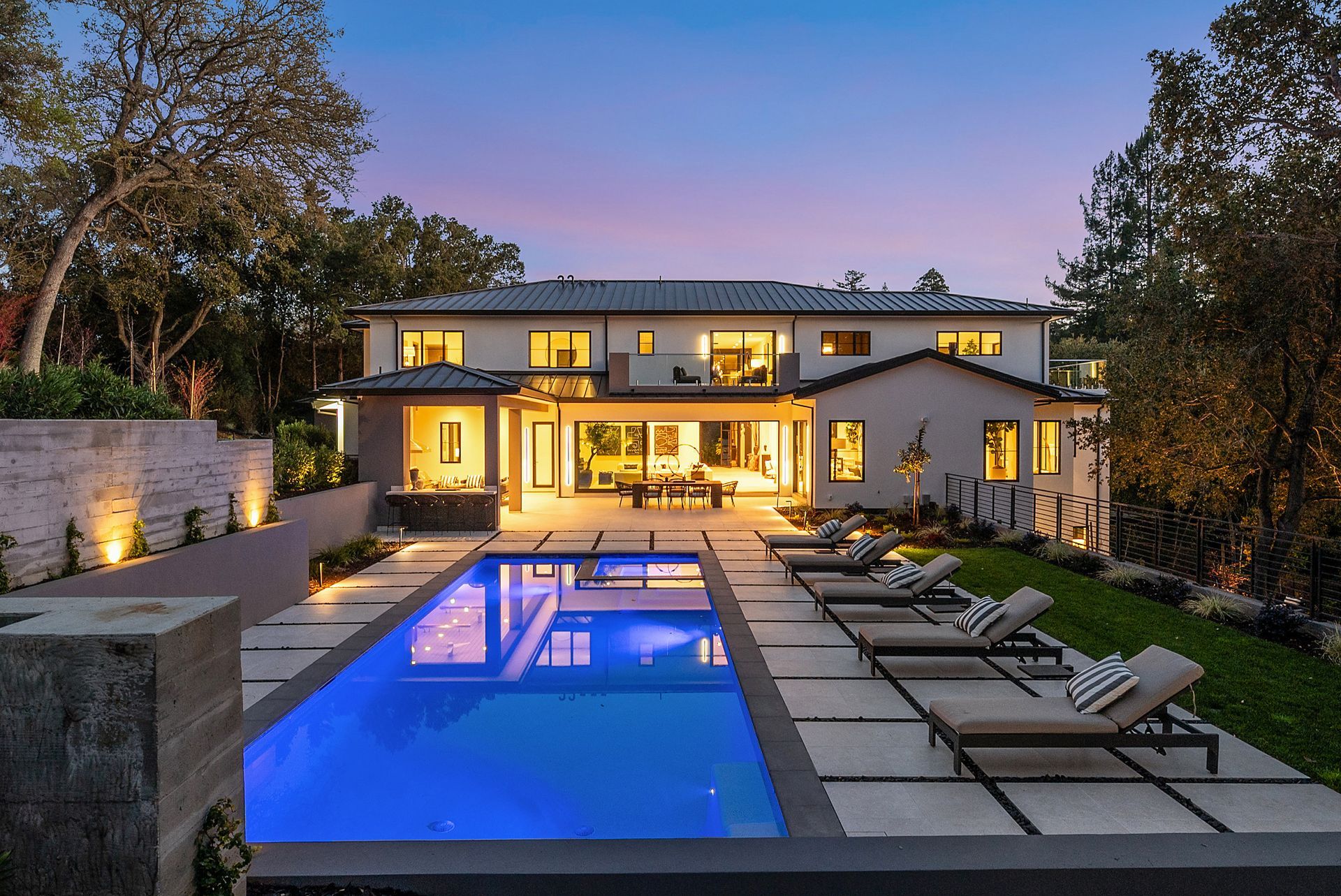 A large house with a large swimming pool in front of it