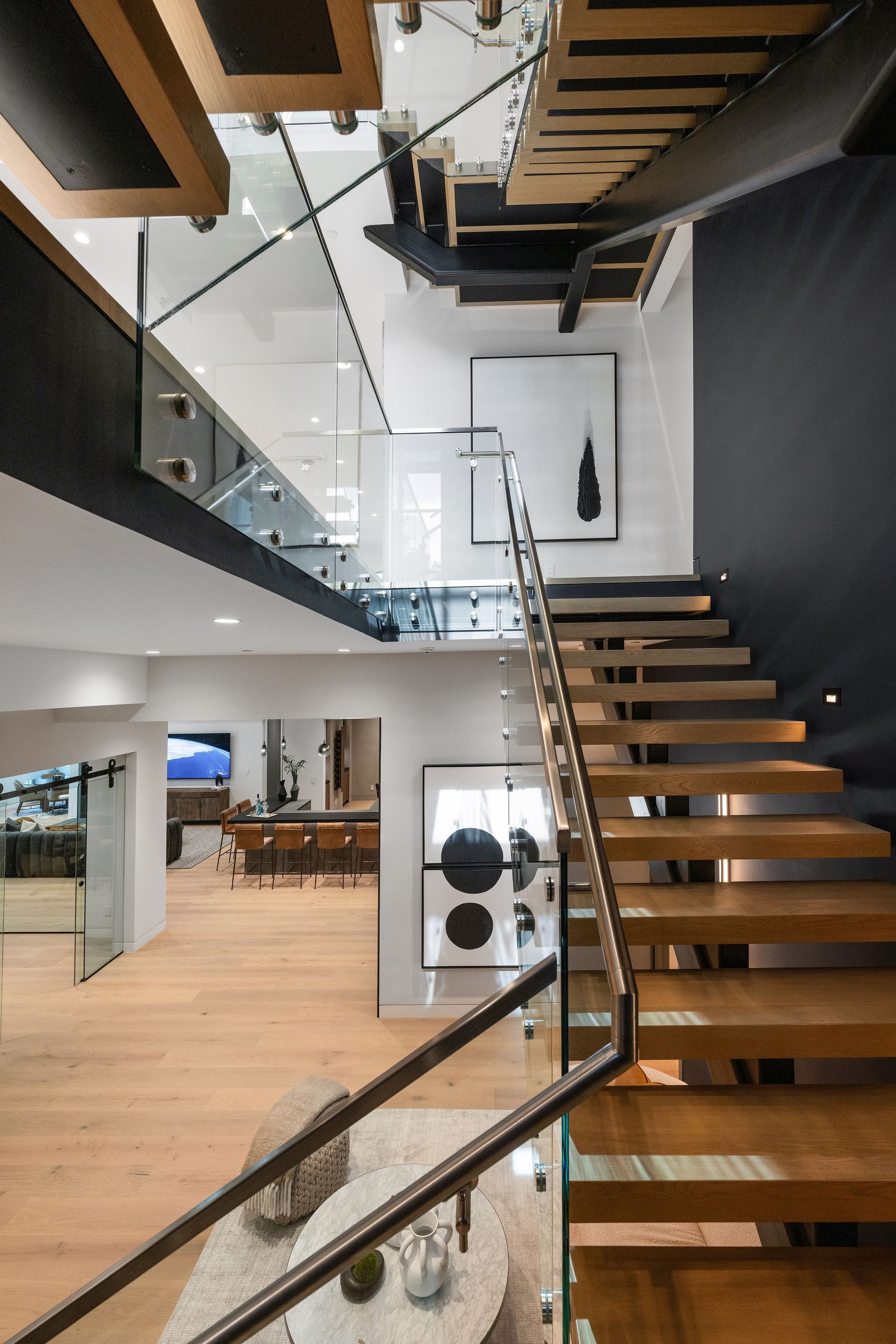 A modern staircase with a glass railing in a house
