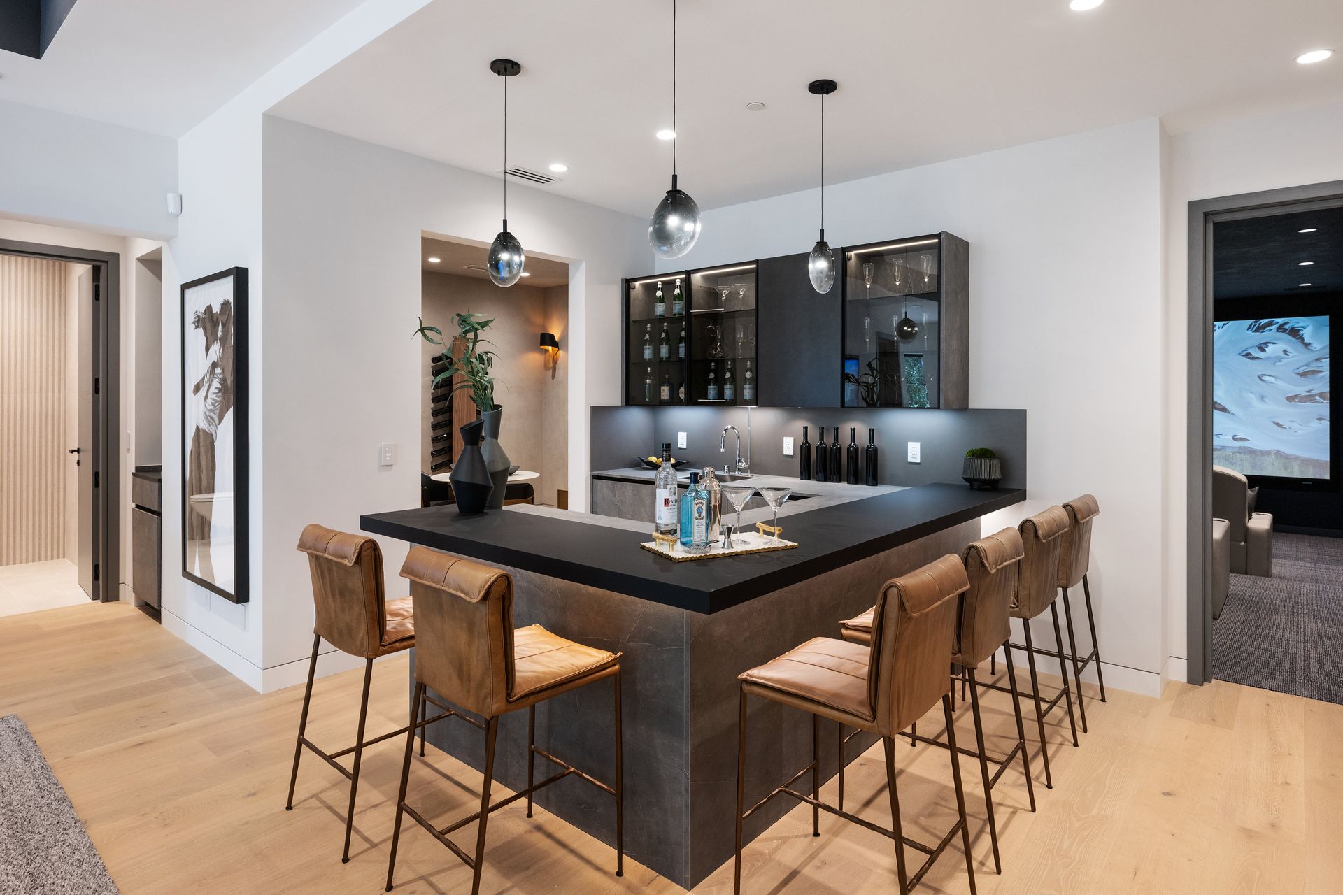 A kitchen with a bar and stools in it