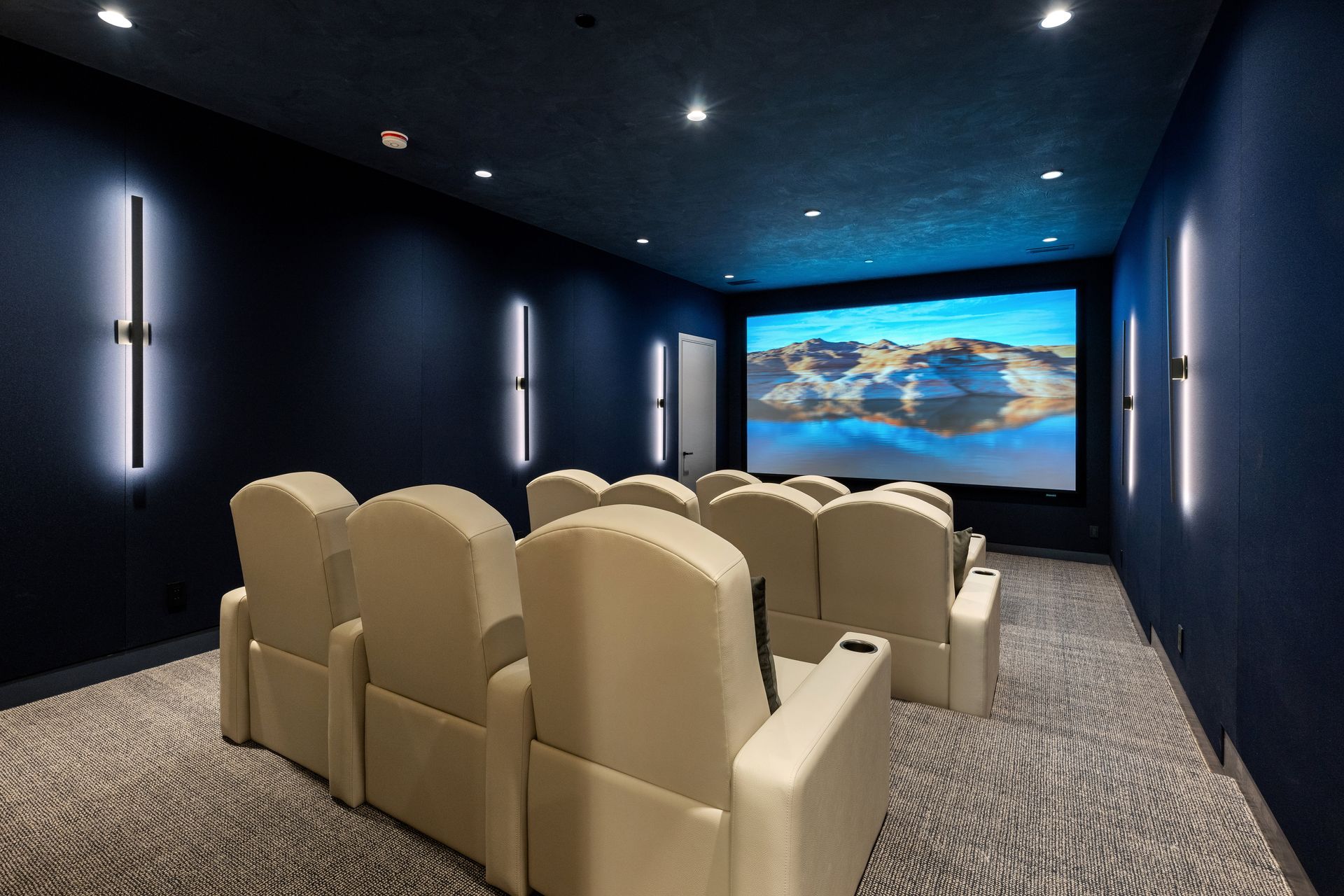 A home theater with a large screen and lots of seats