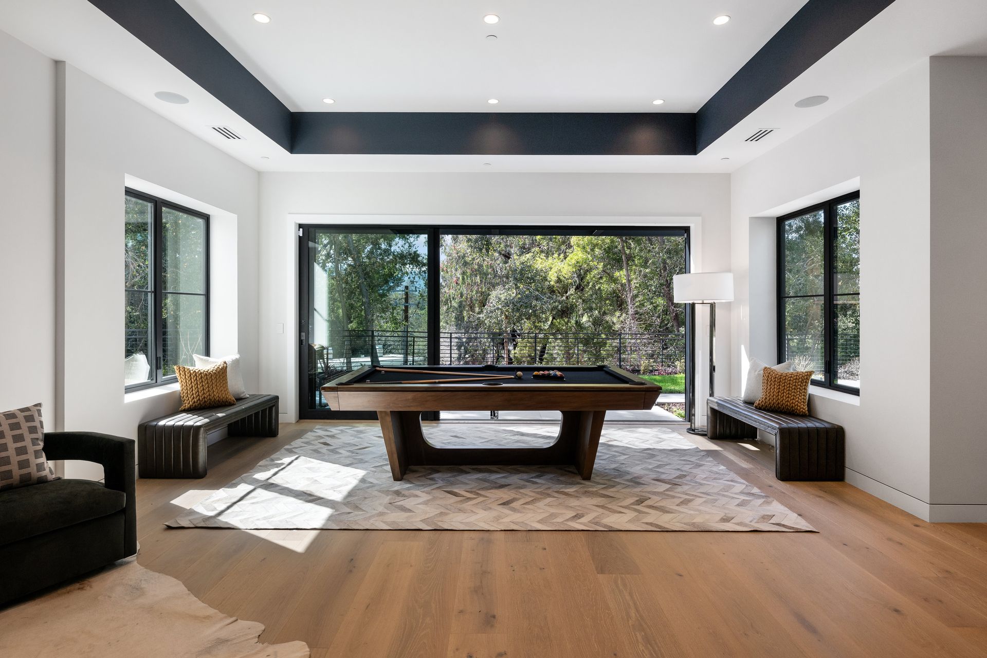 There is a pool table in the middle of the room.