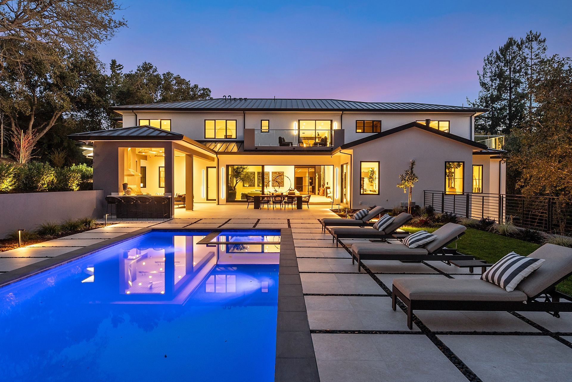 A large house with a large swimming pool in front of it