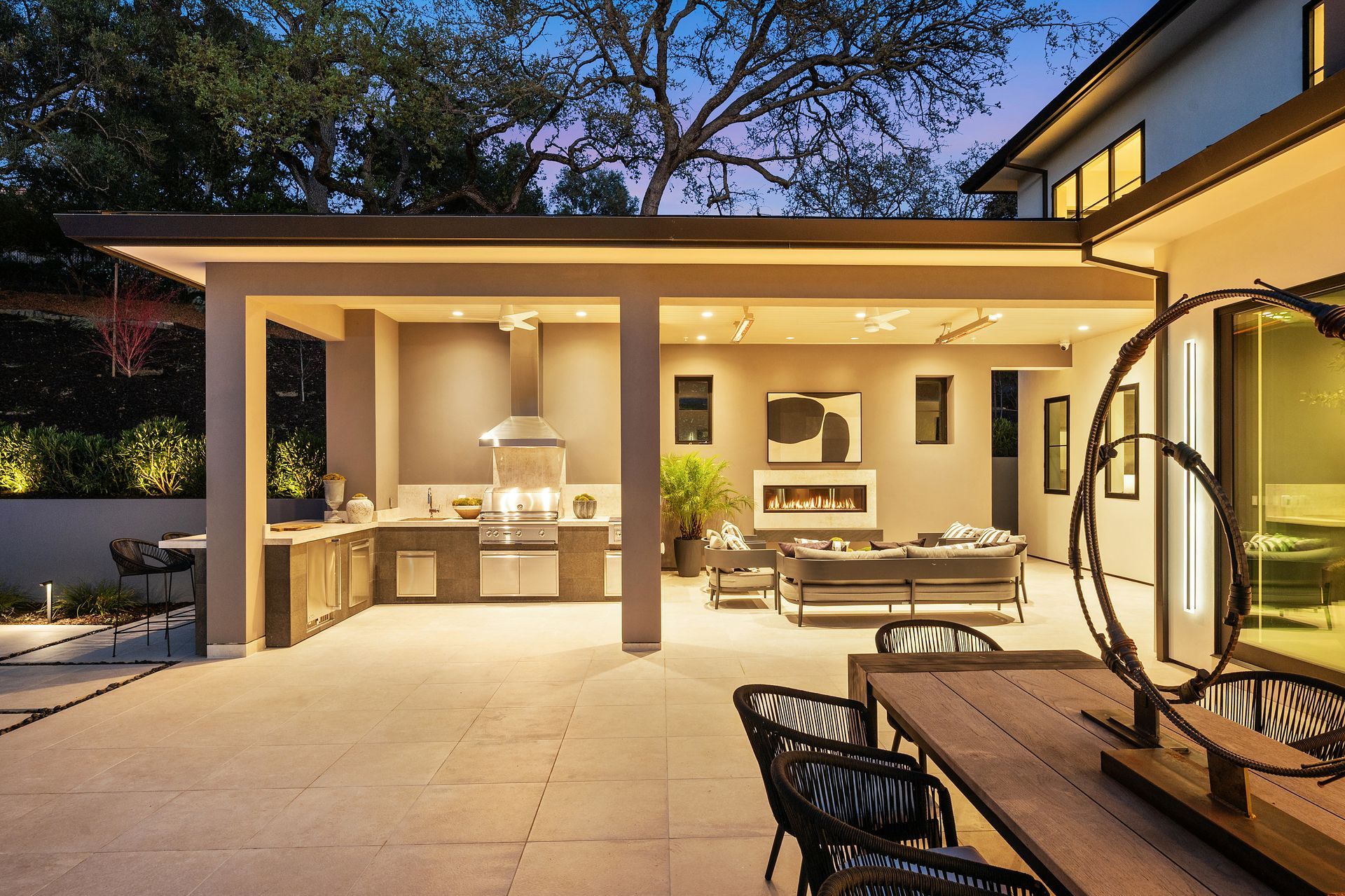A patio with a table and chairs and a kitchen