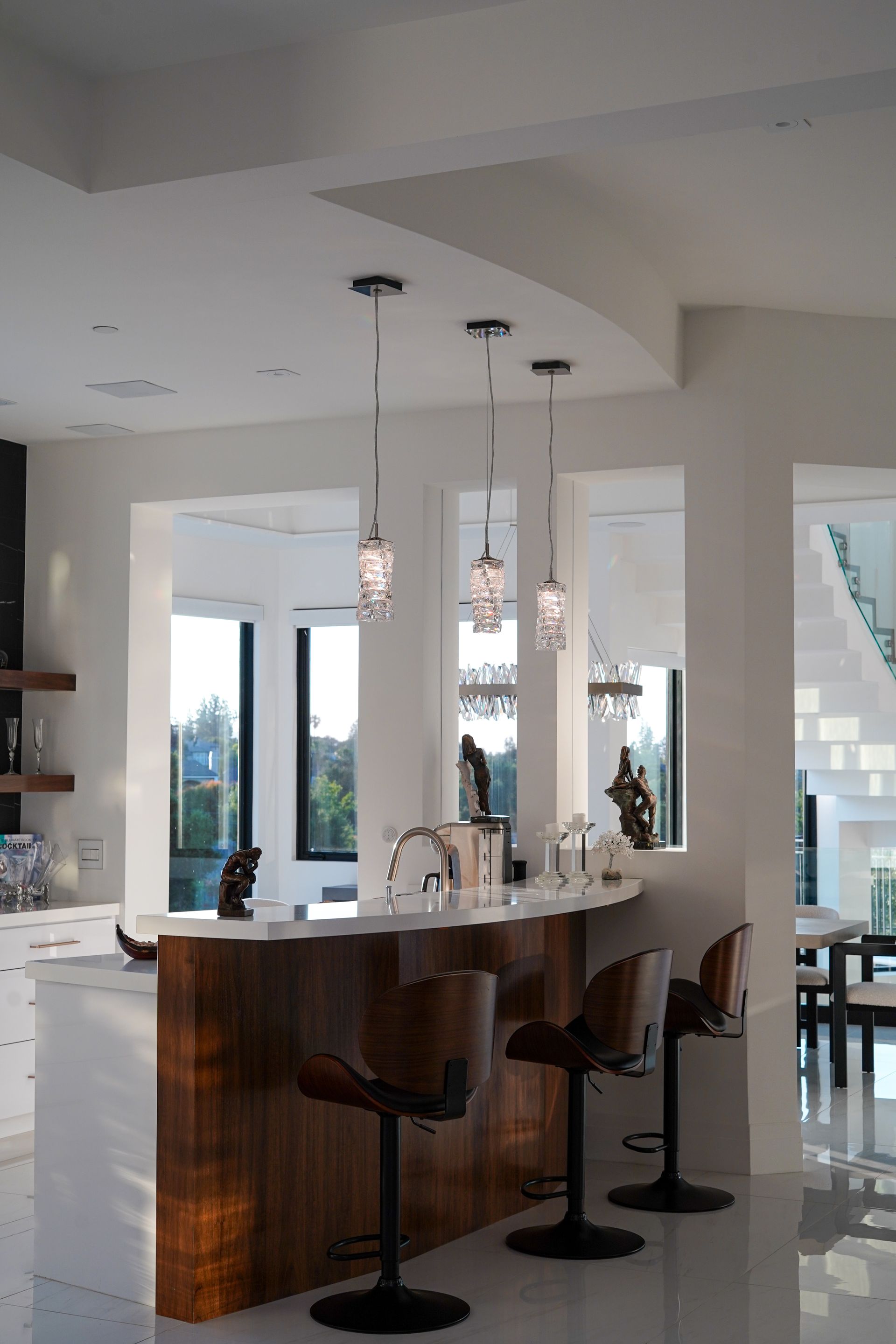 A kitchen with a bar and stools in it