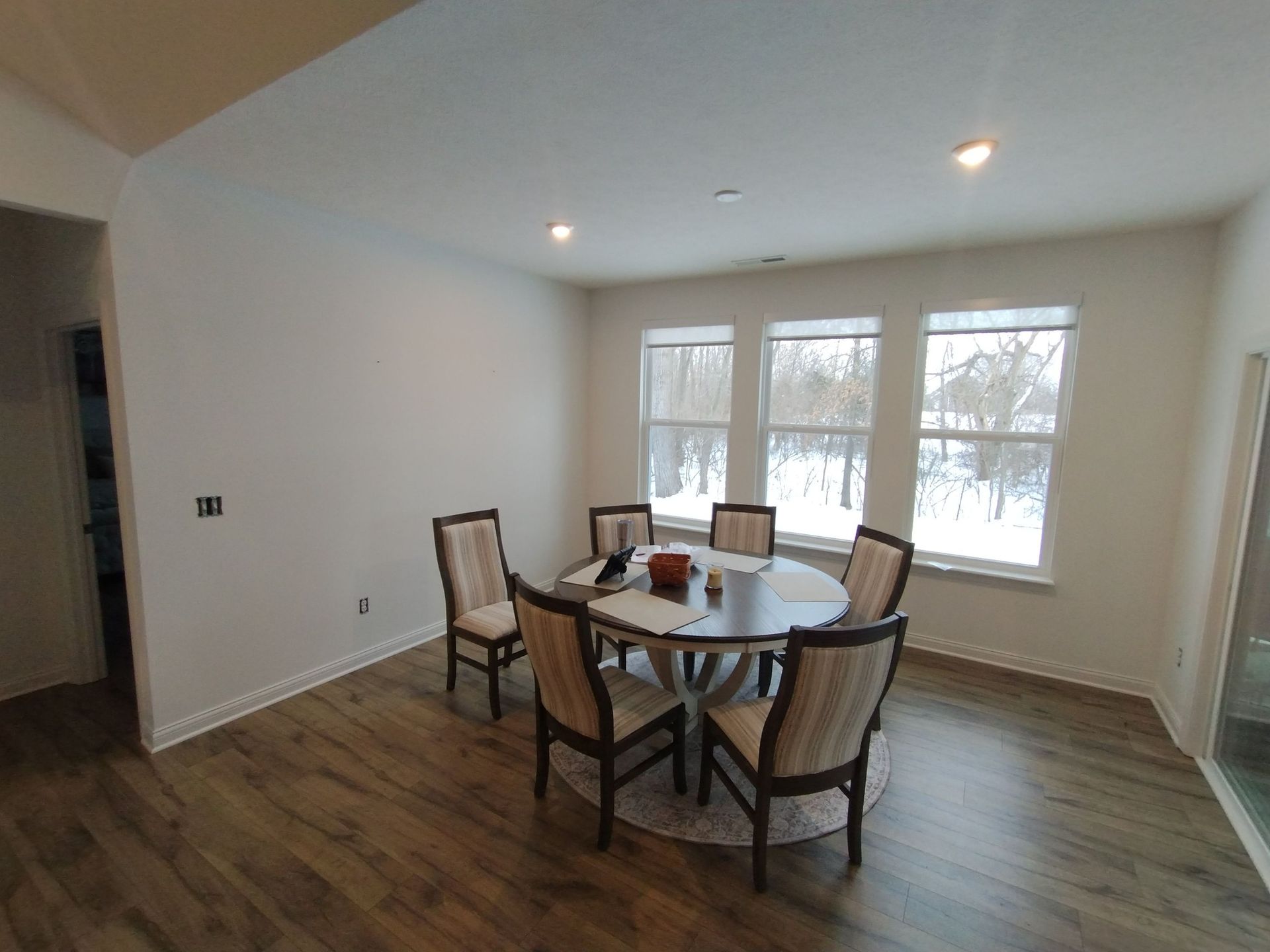 An empty room with blue walls and white shelves