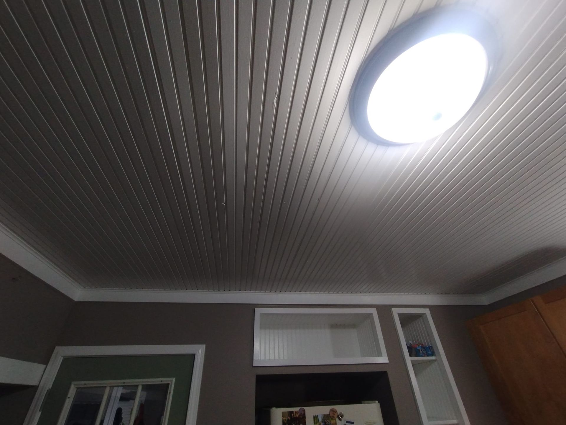 A room with a ceiling that has a light on it