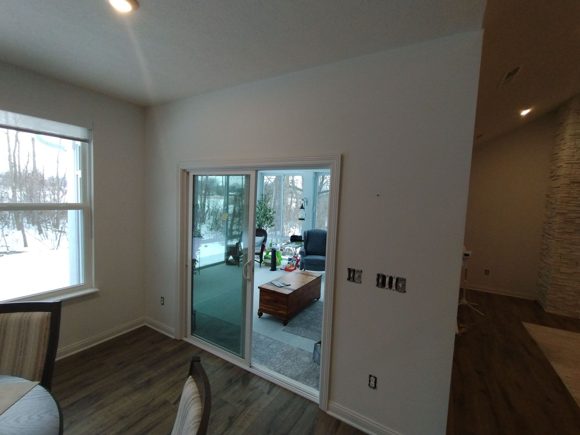 A living room with a sliding glass door leading to a patio.