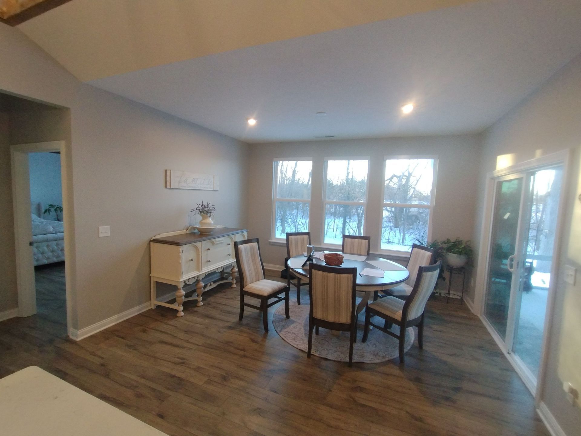 A dining room with a table and chairs in a house.