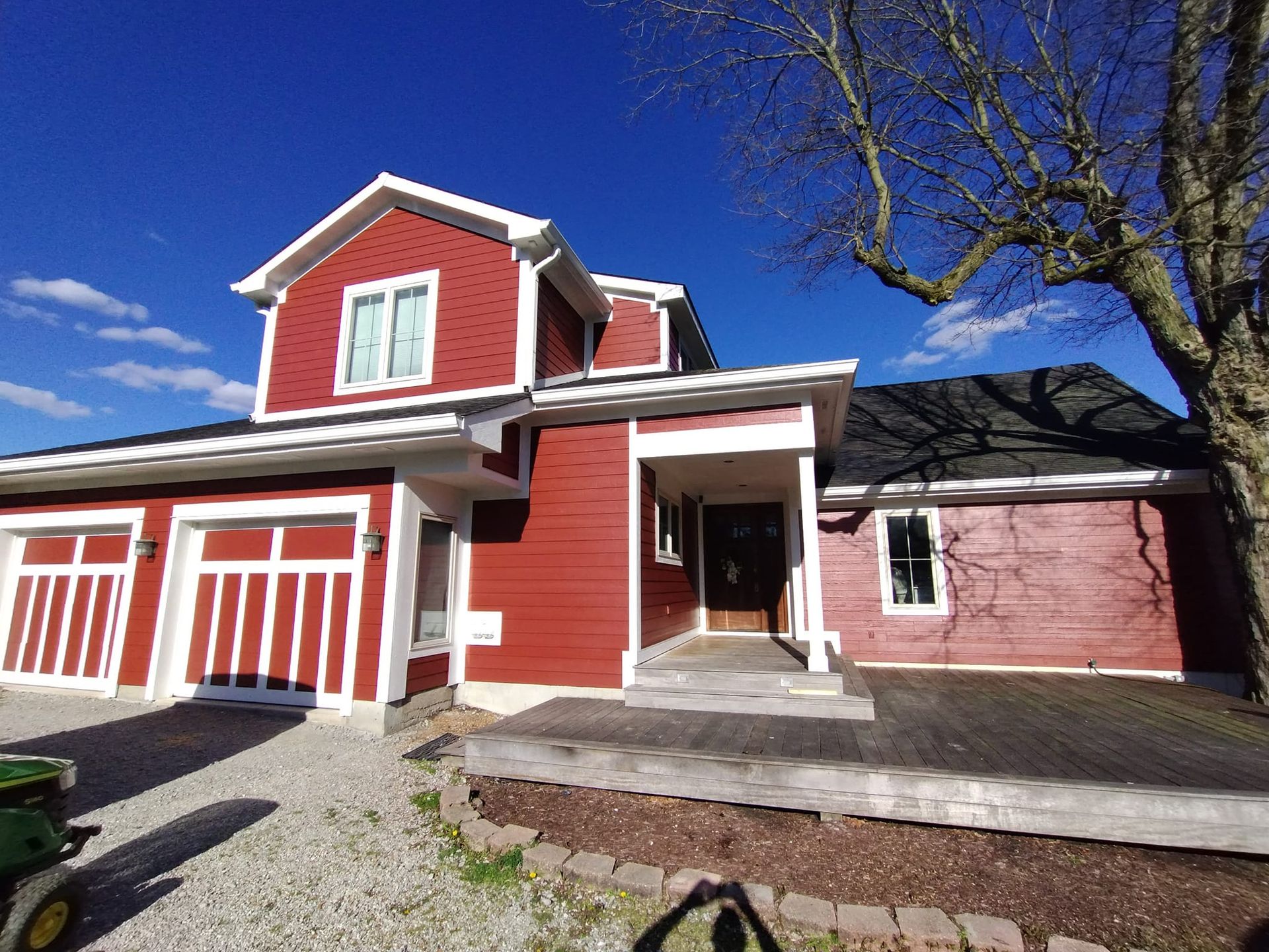 A red house with white trim and a black roof