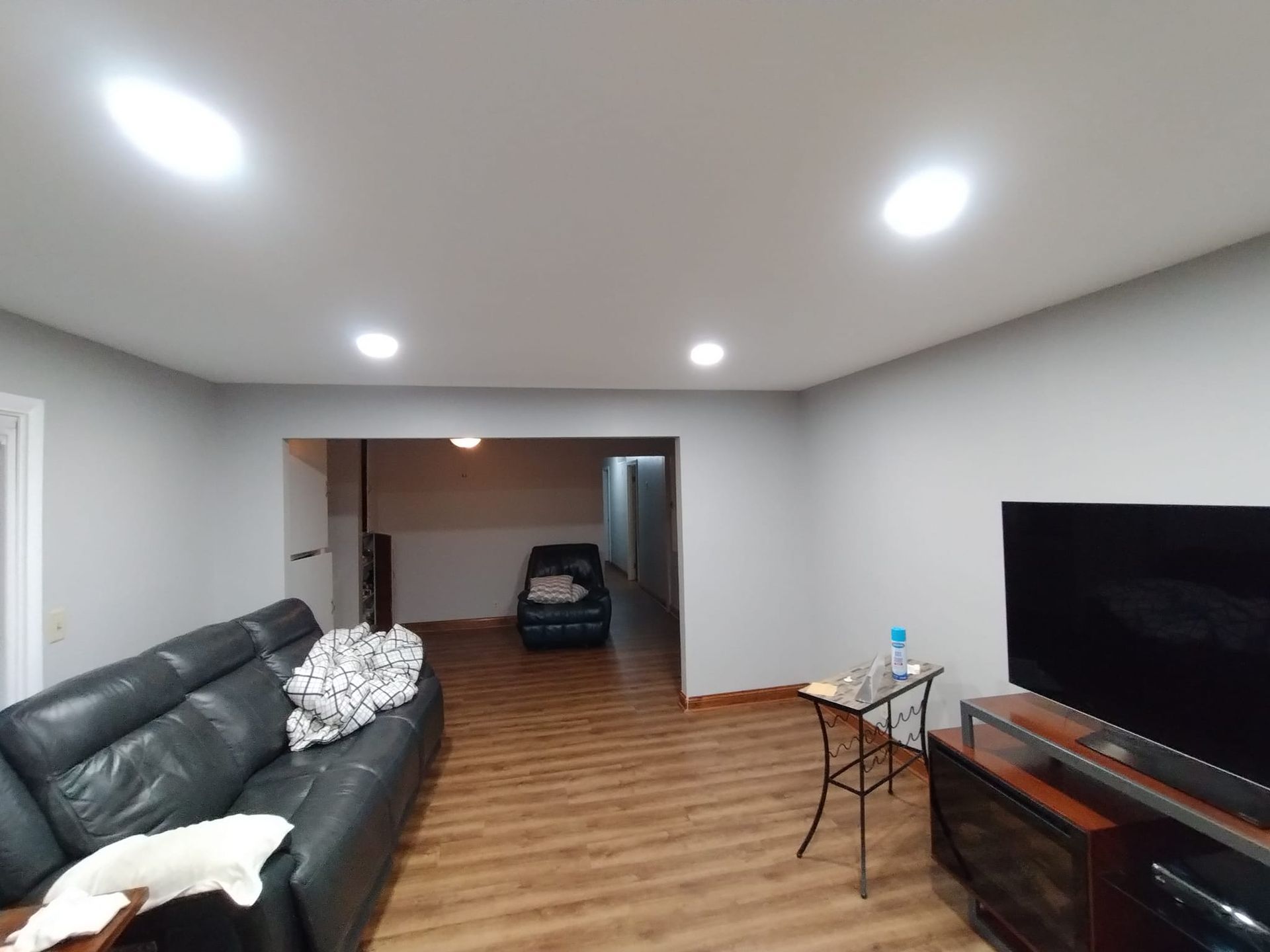 A living room with a couch and a flat screen tv.