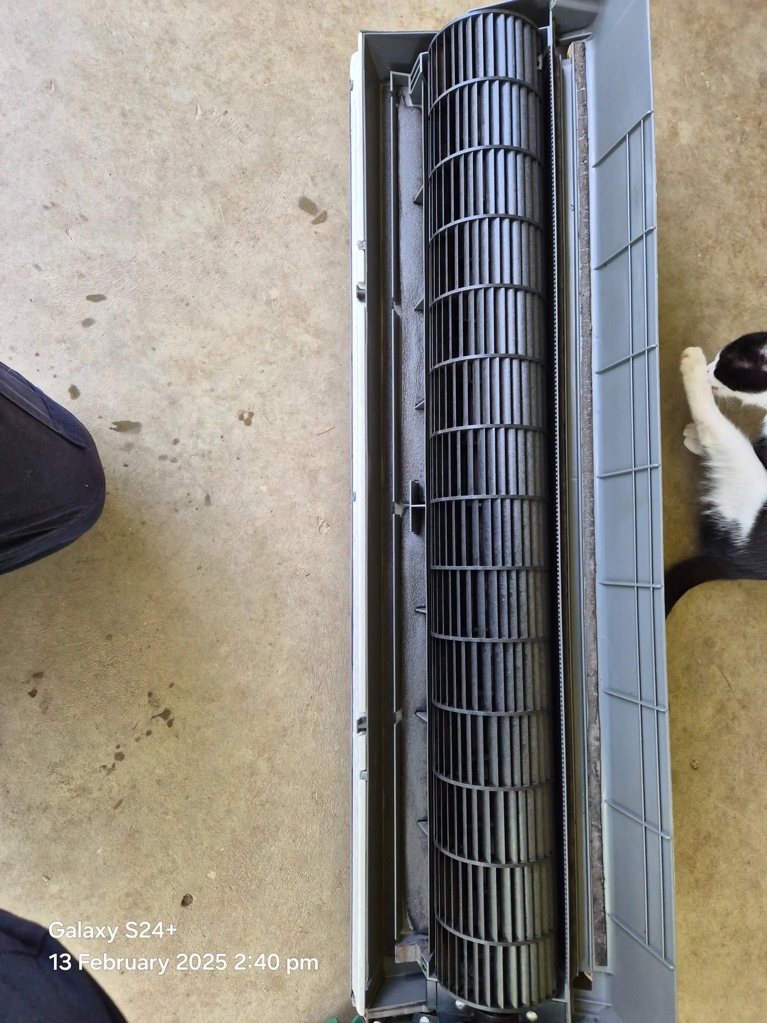 Outdoor compressor unit being mounted on a wall bracket beside a home