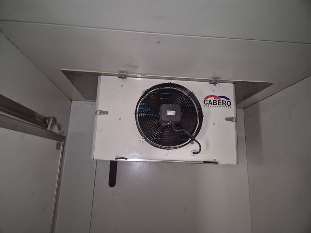Technician servicing an outdoor air conditioning unit at a home in Tumut