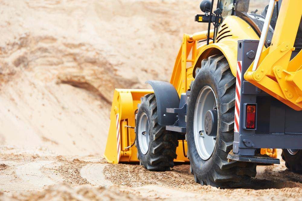 Yellow Construction Loader Working on Sandy Terrain — All things Diesel NT in Tivendale, NT