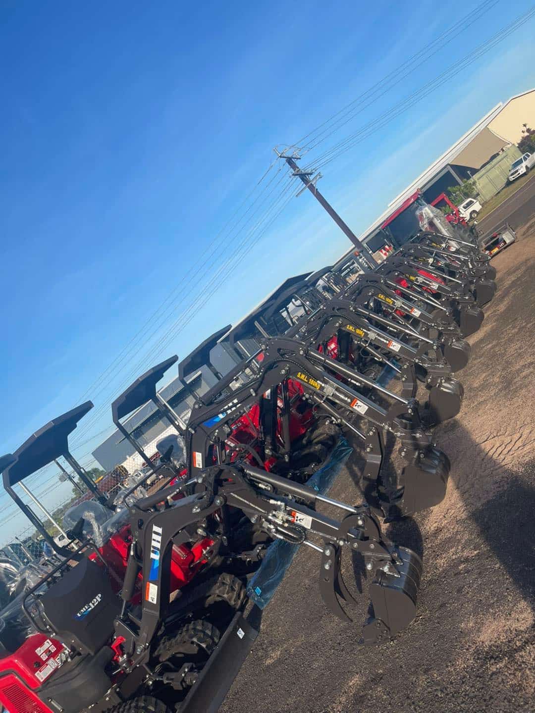 A Row of Tractors Are Lined Up in a Parking Lot — All things Diesel NT in Tivendale, NT 