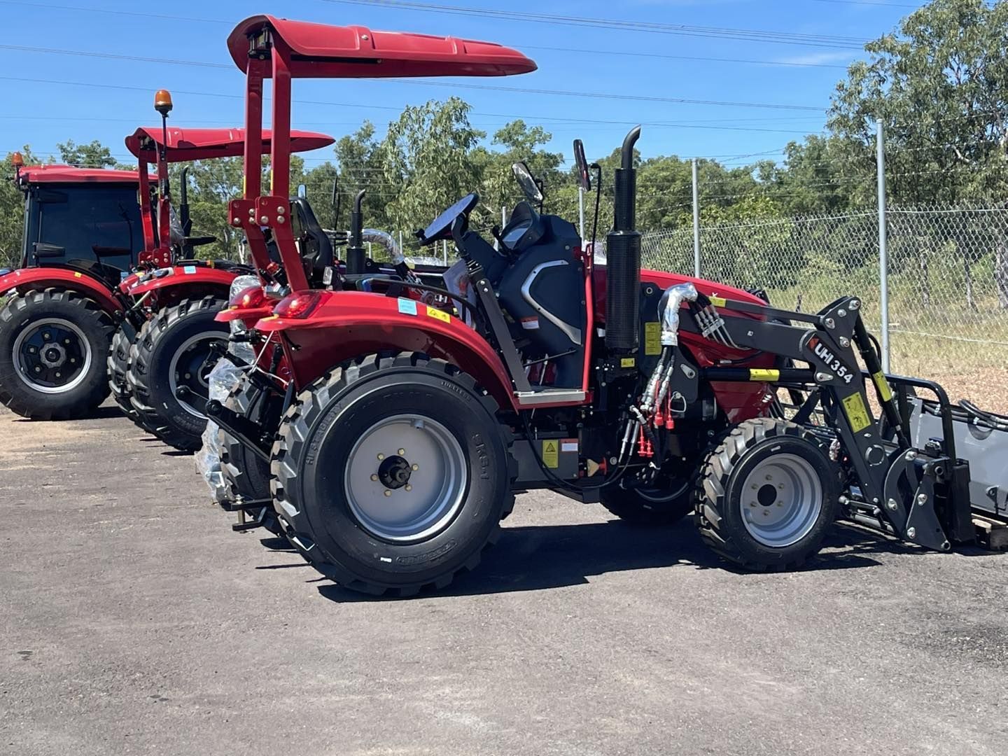 Three red tractors parked in a carpark — All things Diesel NT in Tivendale, NT