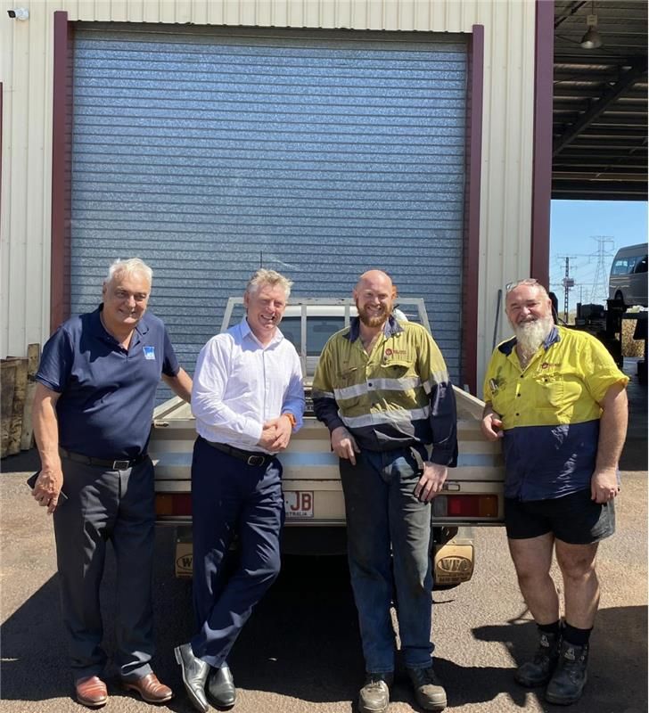 A Group of Men Posing For A Photo In A Mechanics Workshop— All things Diesel NT in Tivendale, NT 