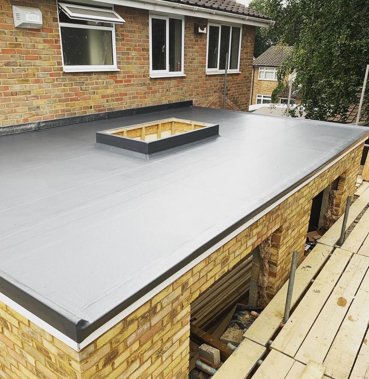 Grey Flat Roofing on House Extension by Leatherhead Roofers HDN Roofing