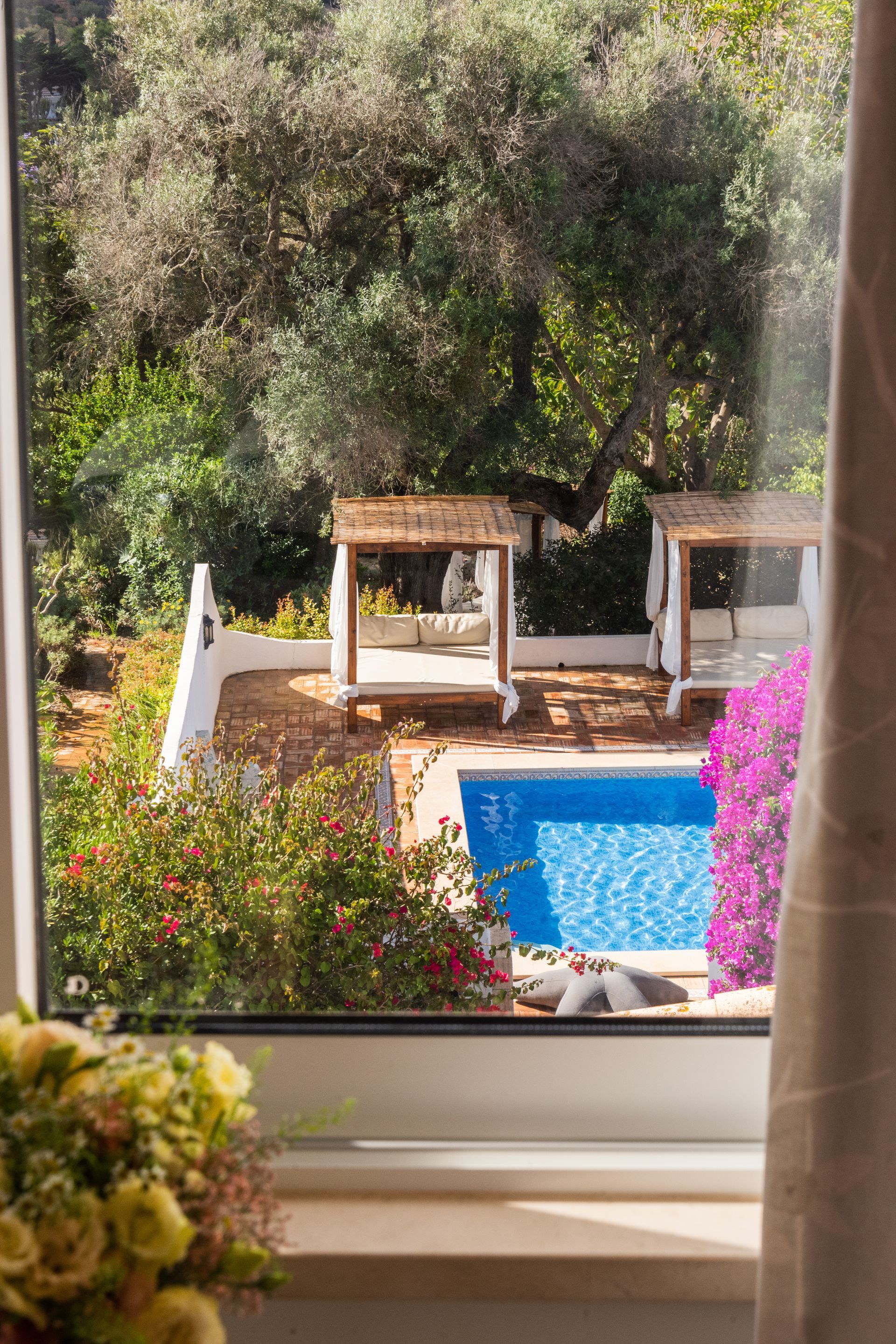 A view of a swimming pool through a window.