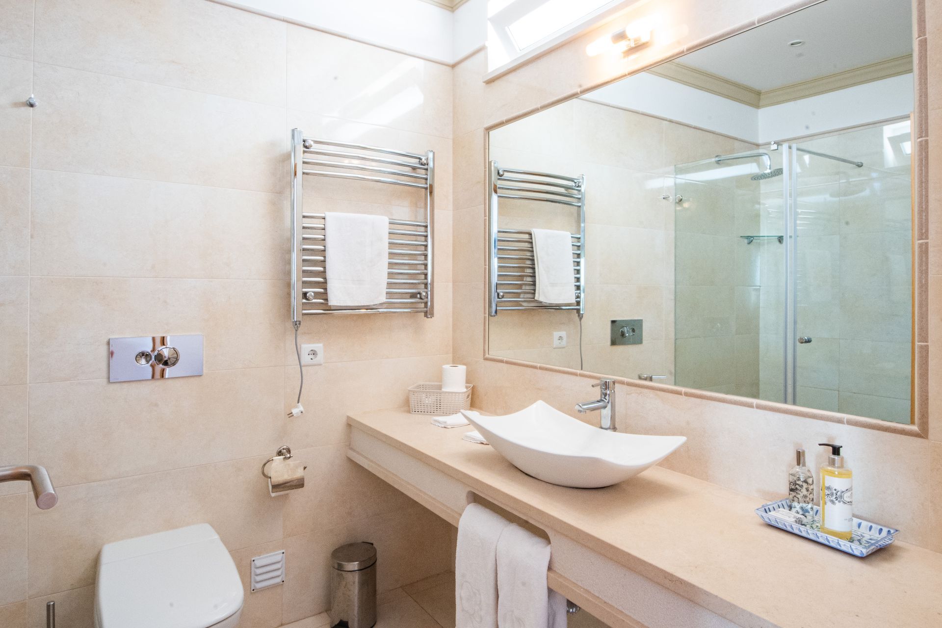 A bathroom with a toilet , sink , and mirror.
