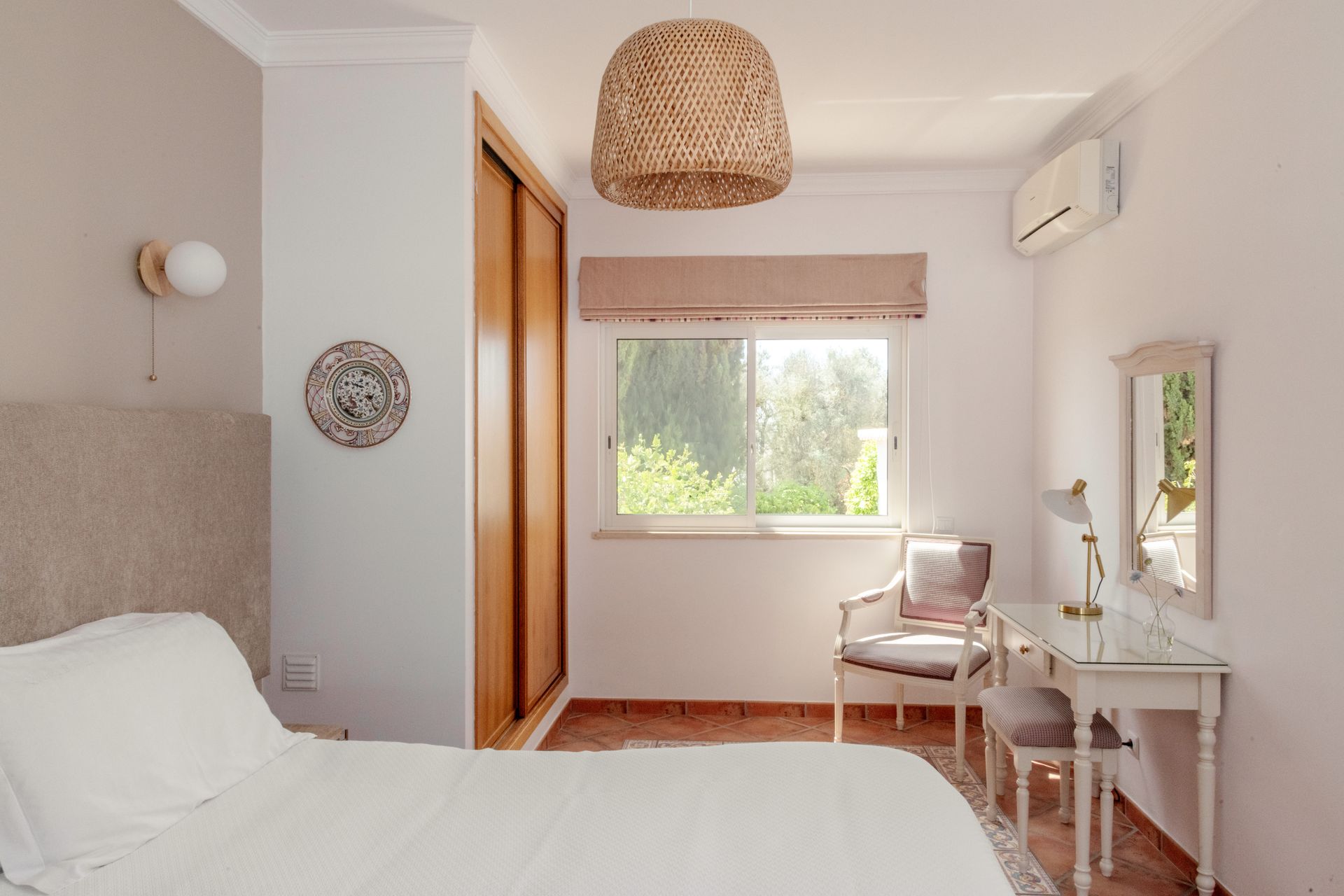 A bedroom with a bed , desk , chair and window