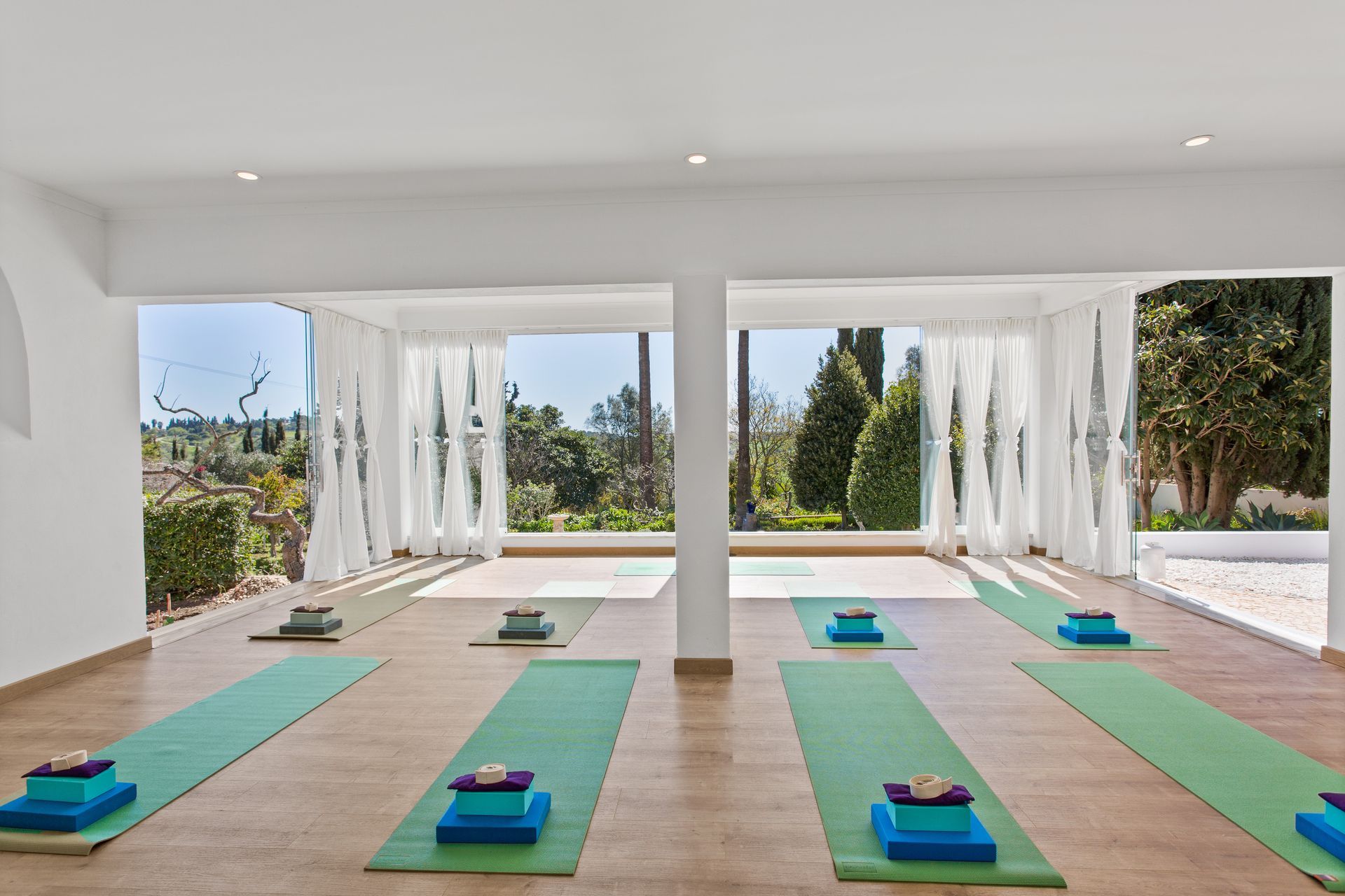 A room with a lot of yoga mats in it.