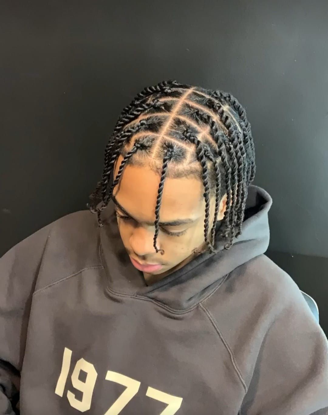 A person wearing a grey hoodie with